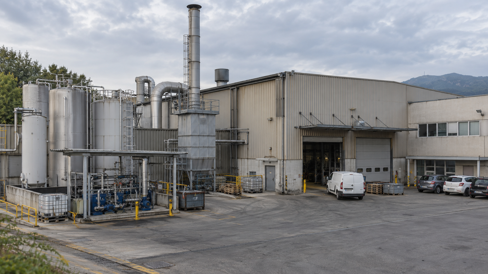 Illustrative exterior of a production site with tanks, extraction equipment, chimney, loading doors and vehicles